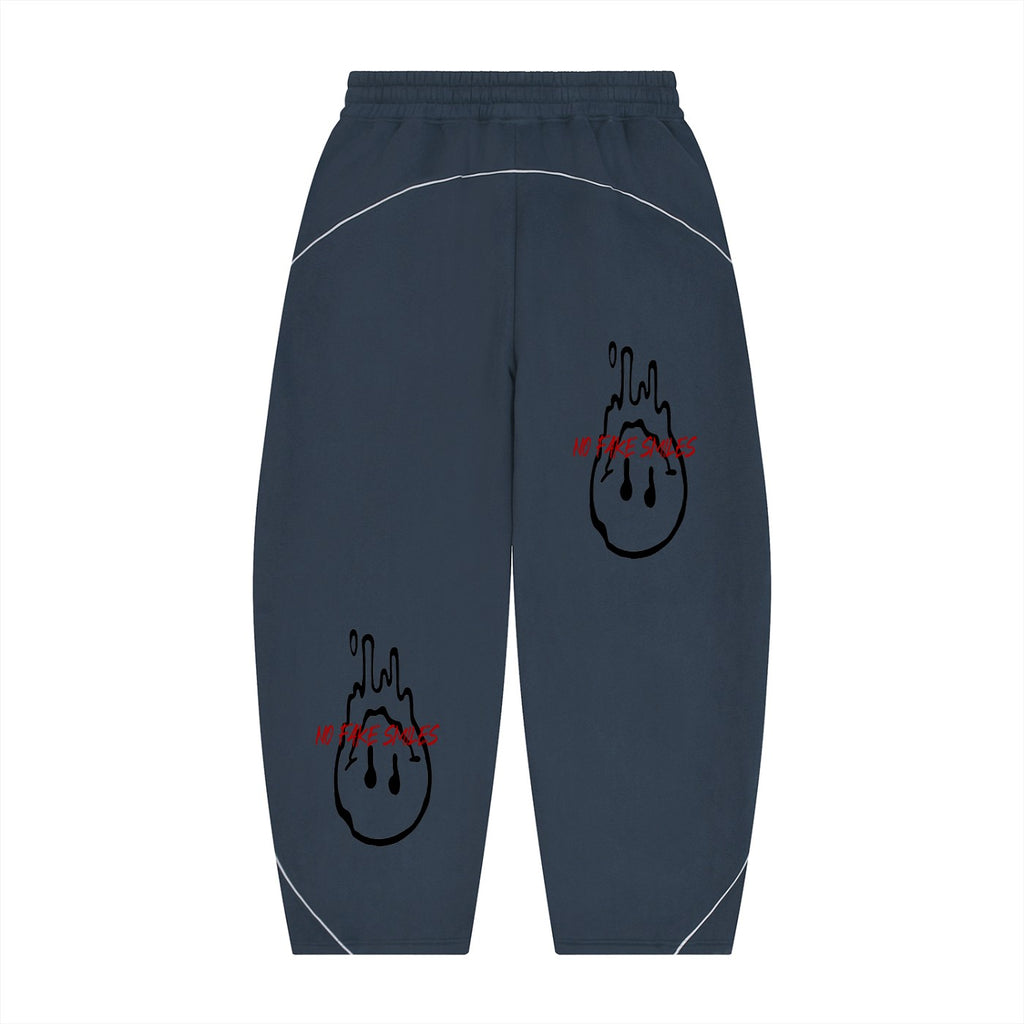 No Fake Smiles navy blue fleece sweatpants with barrel leg silhouette, white piping, and red dripping smiley graphics.