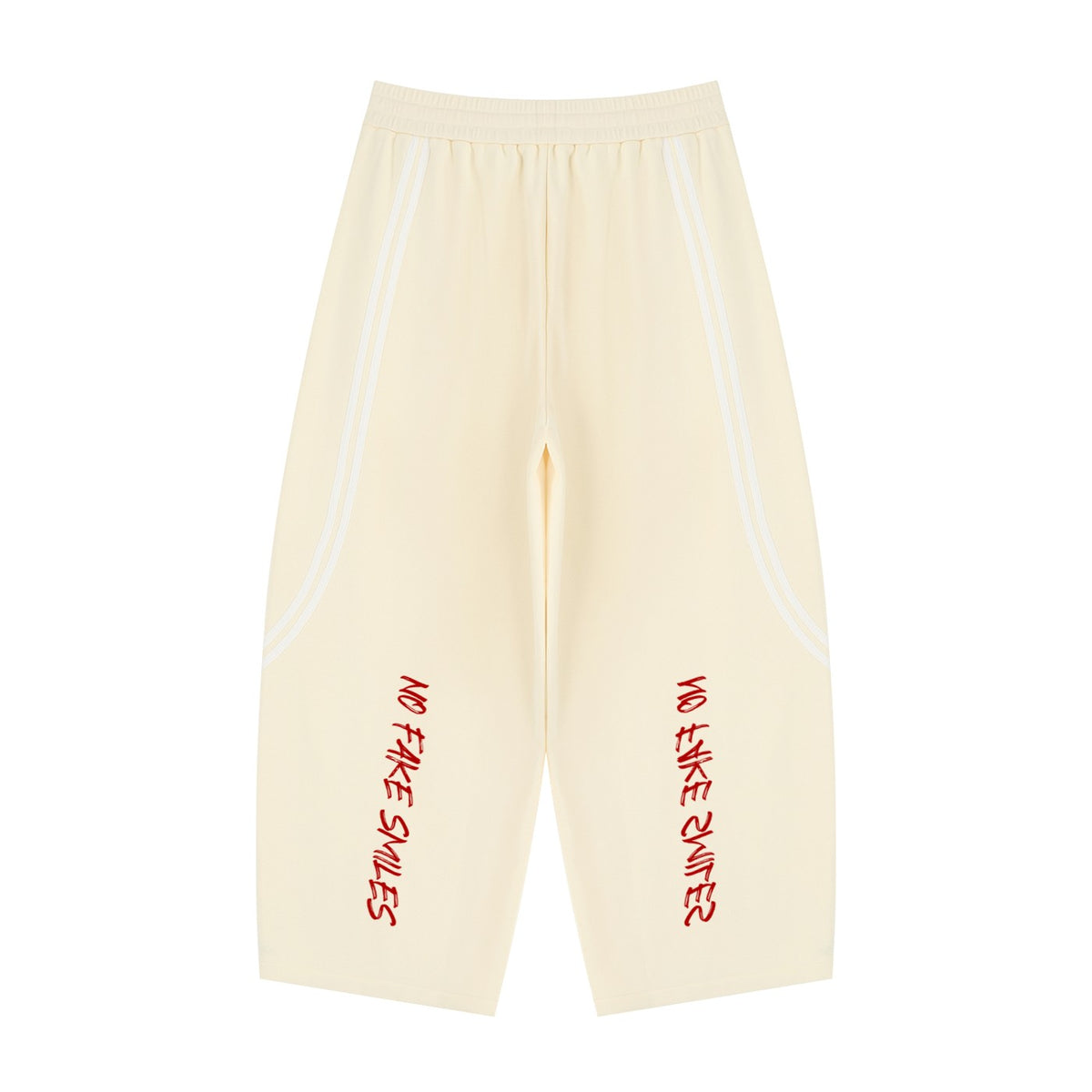 No Fake Smiles wide leg cream sweatpants with white piping detail and red graphic text on the legs.